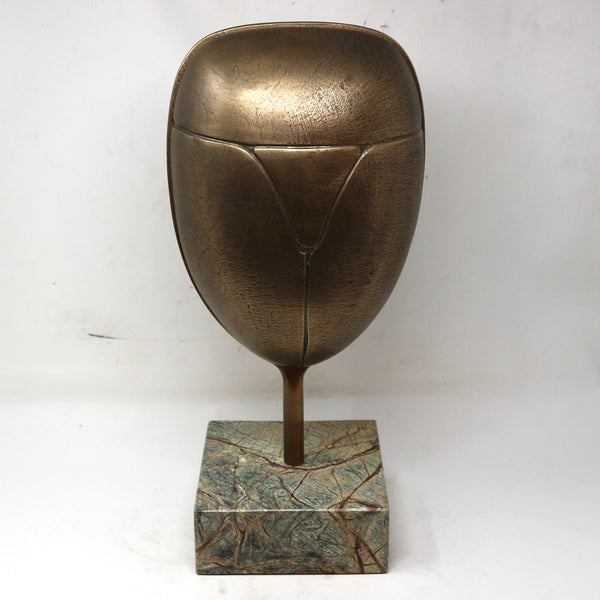 Metal Mask Sculpture on Stone